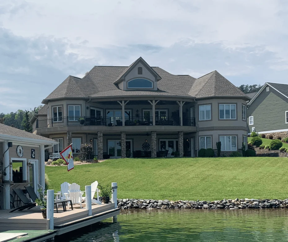Gray architectural shingles on multi-plane roof with gabled dormer over waterfront home